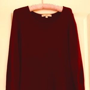 Rich red sweater dress with hemmed detail.